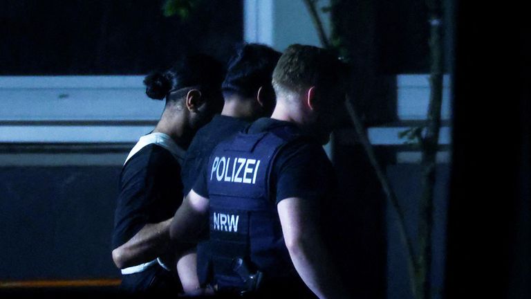 Police officers detain a person in Solingen, Germany. Pic: Reuters